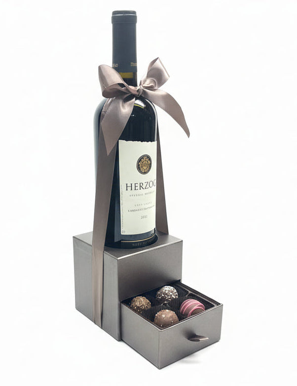 Wine bottle with a bow and chocolates in a box  for Purim 