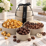 Kosherline 3 tier gift tower featuring caramel popcorn, assorted chocolate pretzels, and espresso beans on marble