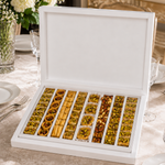 Kosherline assorted baklava gift box with crispy phyllo pastry, roasted nuts, and honey on a formal dining table.