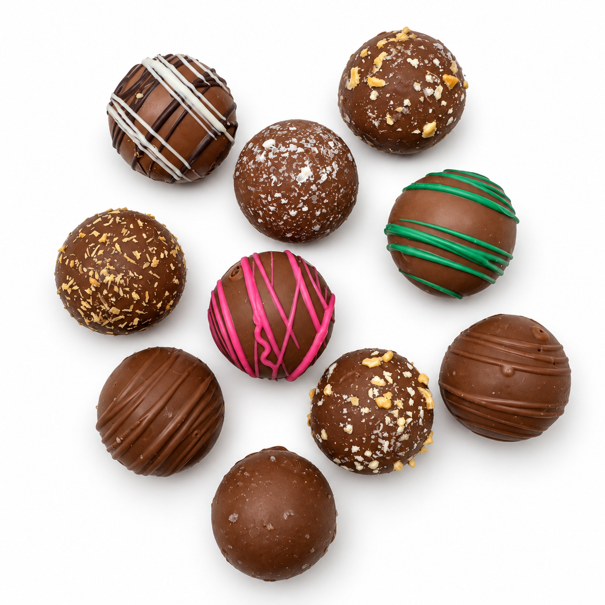 Kosherline assorted chocolate truffles with various toppings and drizzles arranged on a white background