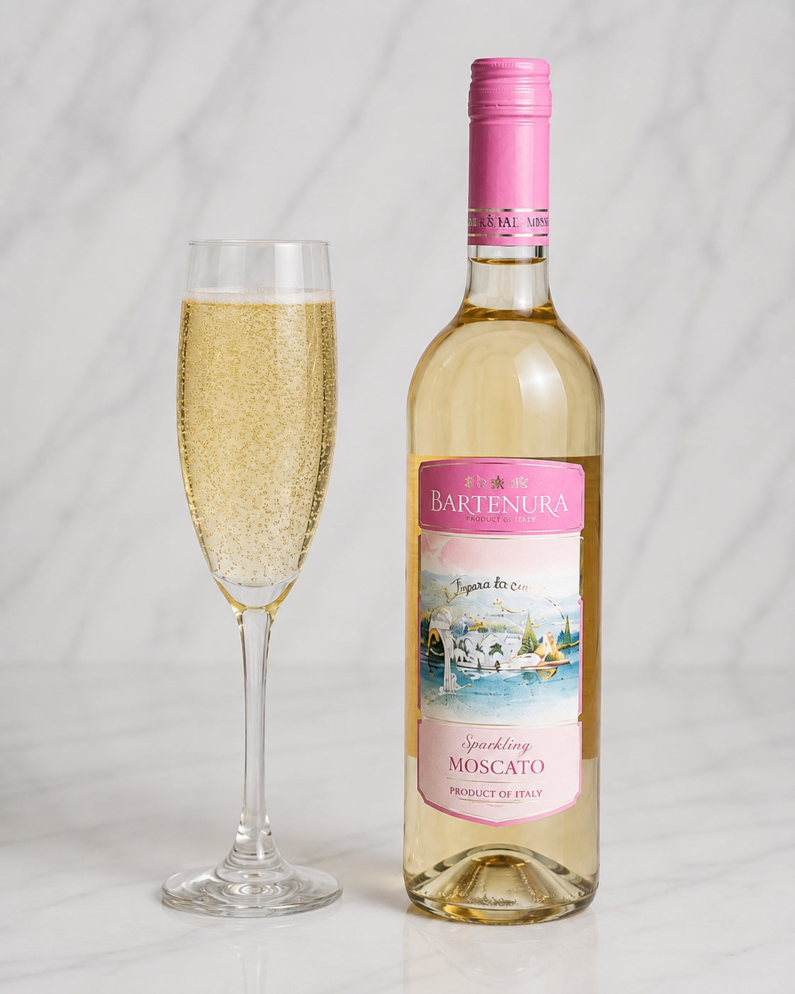 Kosherline Bartenura sparkling Moscato wine bottle and a filled champagne flute on a marble surface