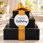 Kosherline Happy Birthday 3-tier chocolate gift tower in black boxes tied with a gold silk ribbon and gift tag.