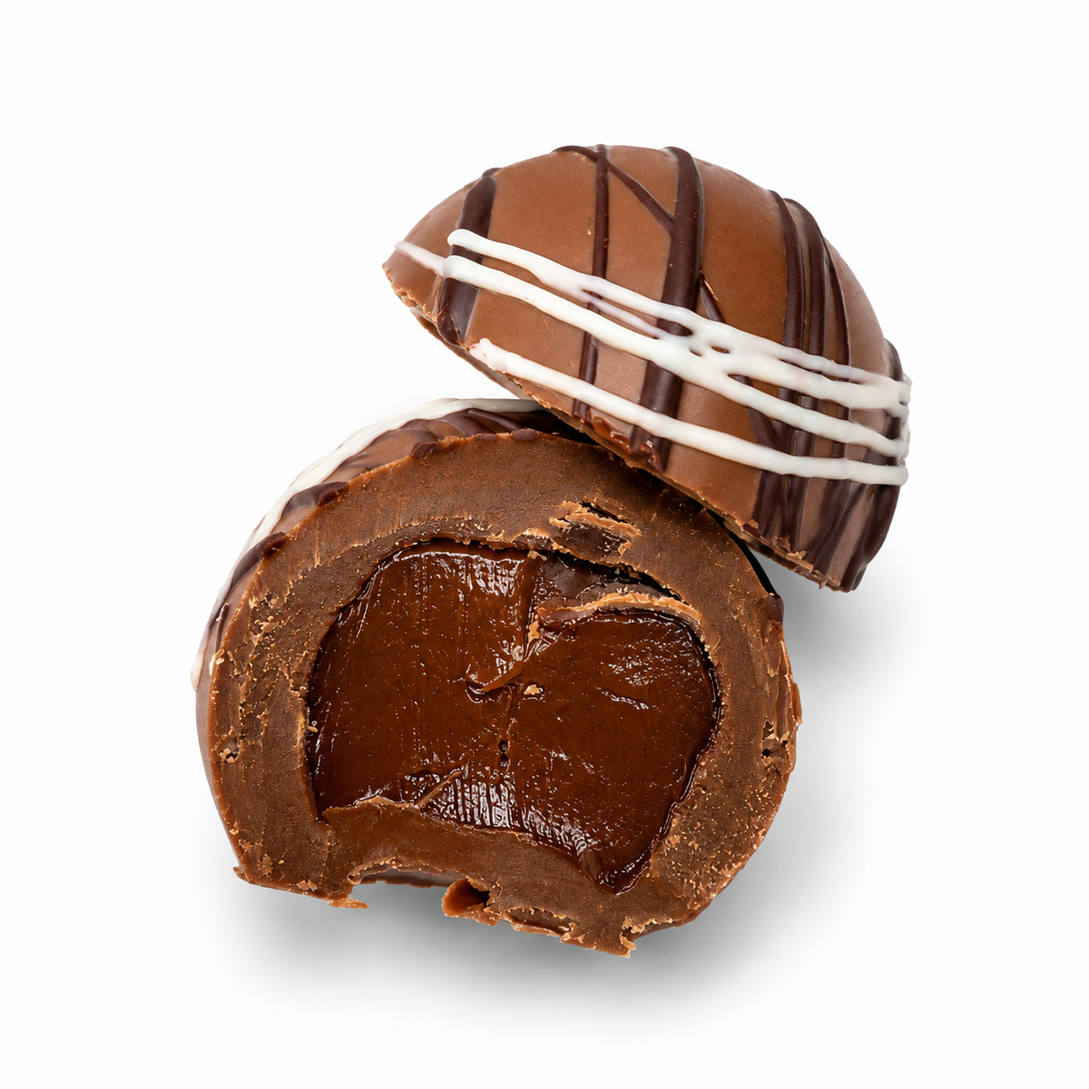 Kosherline assorted truffle cut in half showing a smooth dark chocolate ganache center with a milk chocolate shell