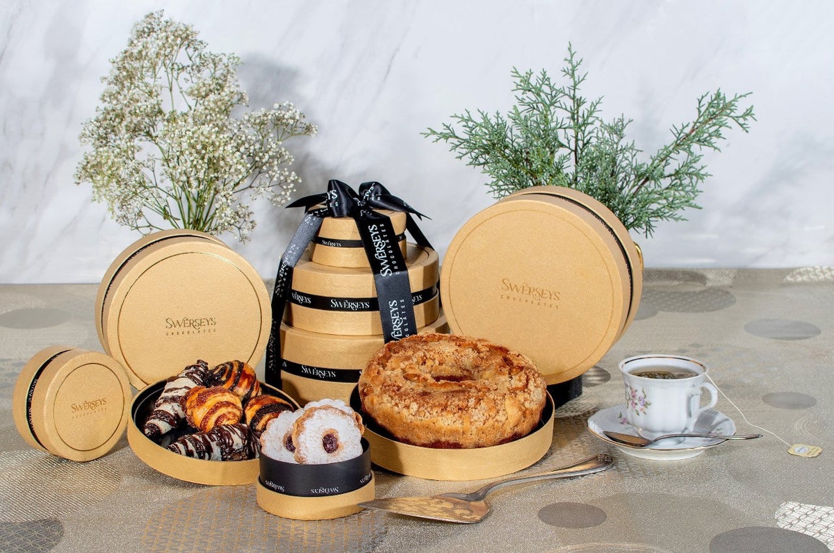 Kosherline 3-tier gold round gift box filled with gourmet Bundt cake, Linzer tarts, and chocolate rugelach pastries.