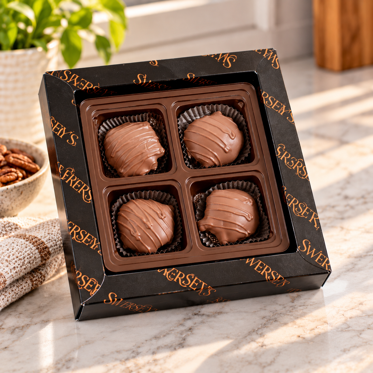 Kosherline 4 Tier Executive Indulgence gift box featuring four gourmet chocolate-covered nut clusters in a tray.