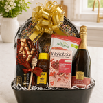 Kosherline Rosh Hashanah gift basket featuring sparkling rosato, honey, herbal tea, and wafers in a black container.
