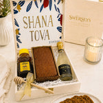 Kosherline Rosh Hashanah gift set in a wooden box with honey cake, sparkling wine, honey bear, and wooden dipper.