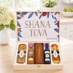 Kosherline Deluxe Rosh Hashanah gift box with honey cake, two bottles of wine, assorted nuts, and dried fruits.