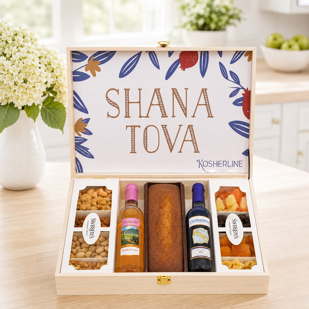 Kosherline Deluxe Rosh Hashanah gift box with honey cake, two bottles of wine, assorted nuts, and dried fruits.