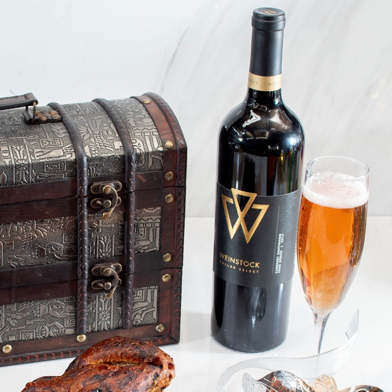 Kosherline Rosh Hashanah gift set featuring a decorative treasure chest, premium wine bottle, and chocolate babka cake.