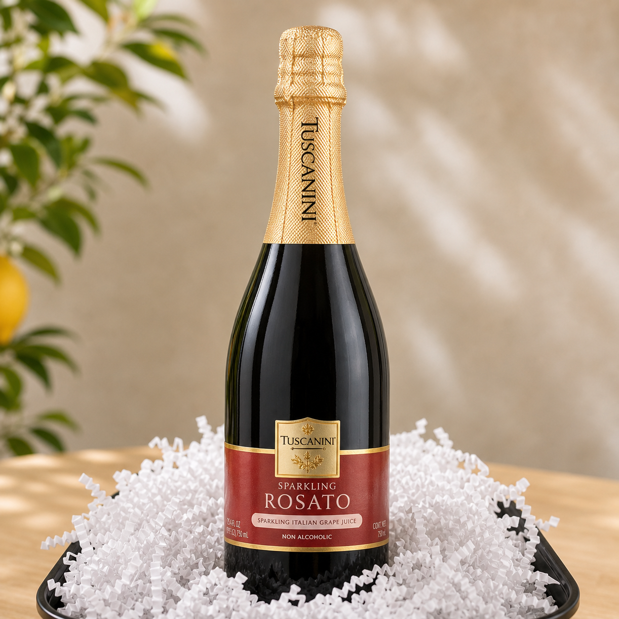 Kosherline bottle of Tuscanini sparkling rosato grape juice nestled in white crinkle paper on a black tray